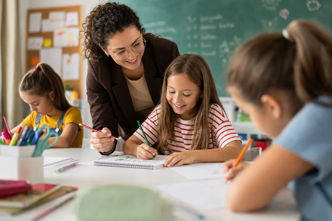 A teacher working with students in a classroom
